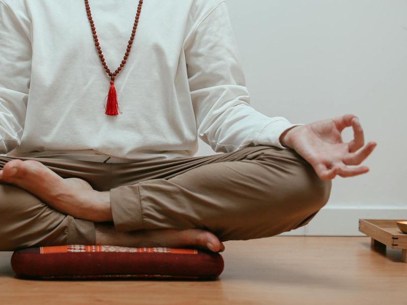 Close-up shot of a person's hands in a specific yoga mudra.